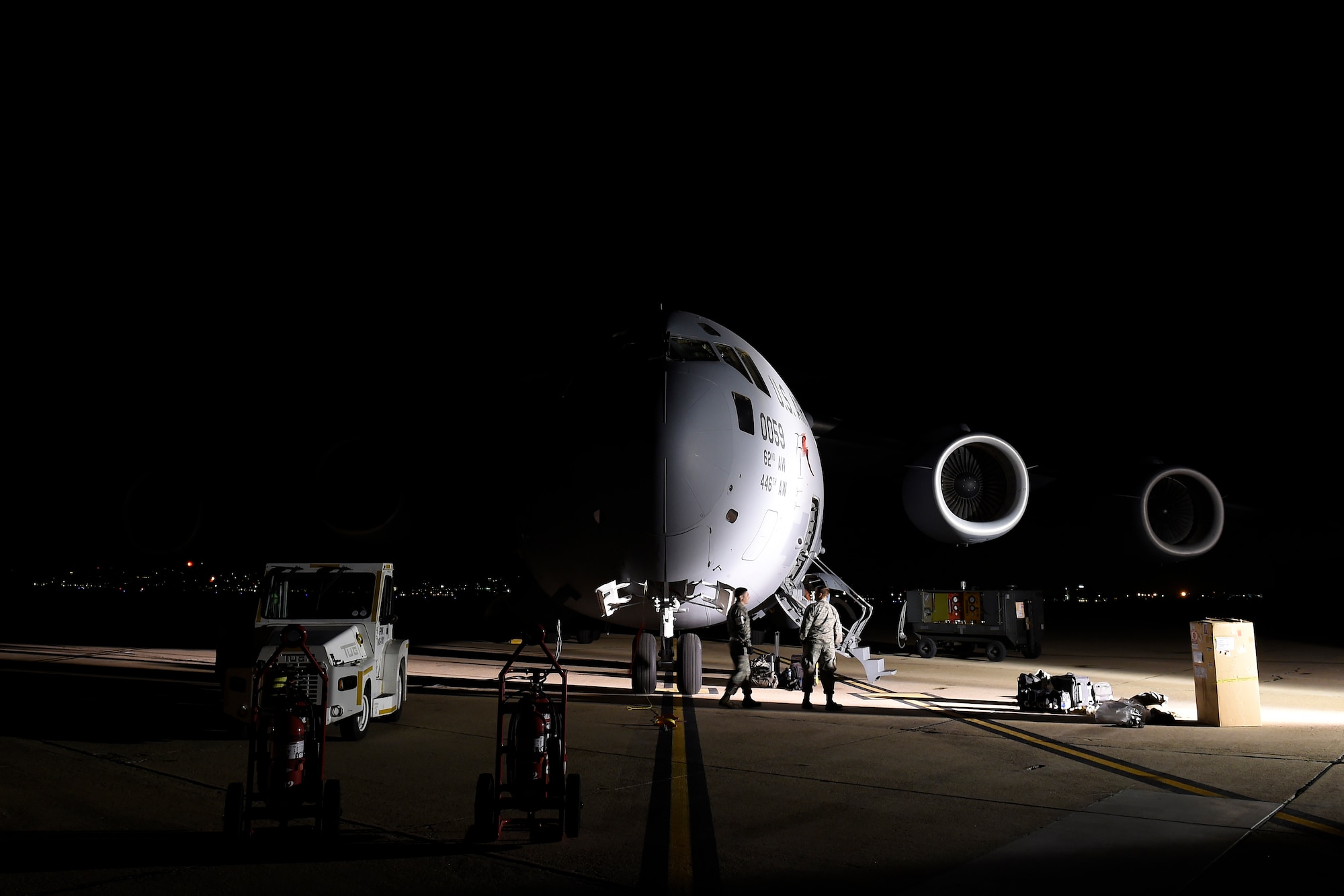 Staff Sgt. Jeremy Aiumo, and Staff Sgt. Tanner Evjene, 62nd Aircraft Maintenance Squadron crew chiefs, help remove a hydraulic reservoir on a C-17 Globemaster III, Feb. 18, 2016 at North Island Naval Station, Calif. Both Airmen were part of a four person McChord Maintenance Recovery Team from Joint Base Lewis-McChord, Wash. (U.S. Air Force photo/Tech Sgt. Tim Chacon)