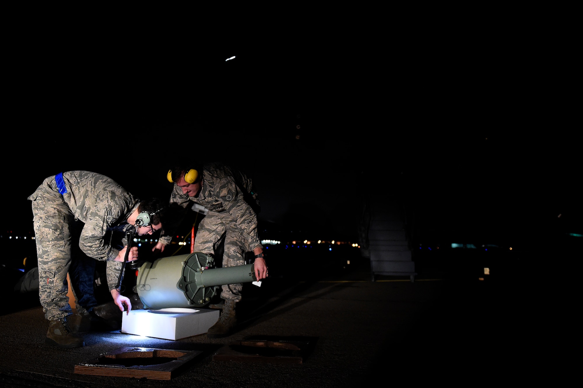 Senior Airman Jacob Remstrom (left) and Staff Sgt. Nathan Kuhn, 62nd Maintenance Squadron hydraulics systems specialists, unbox a hydraulic reservoir  Feb. 18, 2016 at North Island Naval Station, Calif. Remstrom and Kuhn were part of a four person McChord Maintenance Recovery Team sent from Joint Base Lewis-McChord, Wash., to repair a C-17 Globemaster III. (U.S. Air Force photo/Tech Sgt. Tim Chacon)