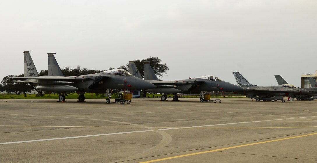 An F-15C Eagle assigned to the 493rd Fighter Squadron sits on the flightline alongside Portuguese F16M during Real Thaw 2016 at Beja Air Base, Portugal, Feb. 21, 2016. Real Thaw offers training opportunities for Liberty Airmen to train and hone operational skills in a non-combat zone. RT16, taking place from February 22-March 3, is an exercise planned and conducted by the Portuguese air force, under the aegis of its Air Command, who are responsible for training and readying the operational units, through air operations in the defense of national interests, as well as through the participation in military operations in several international cooperation frameworks. (U.S. Air Force photo by Senior Airman Dawn M. Weber/Released)