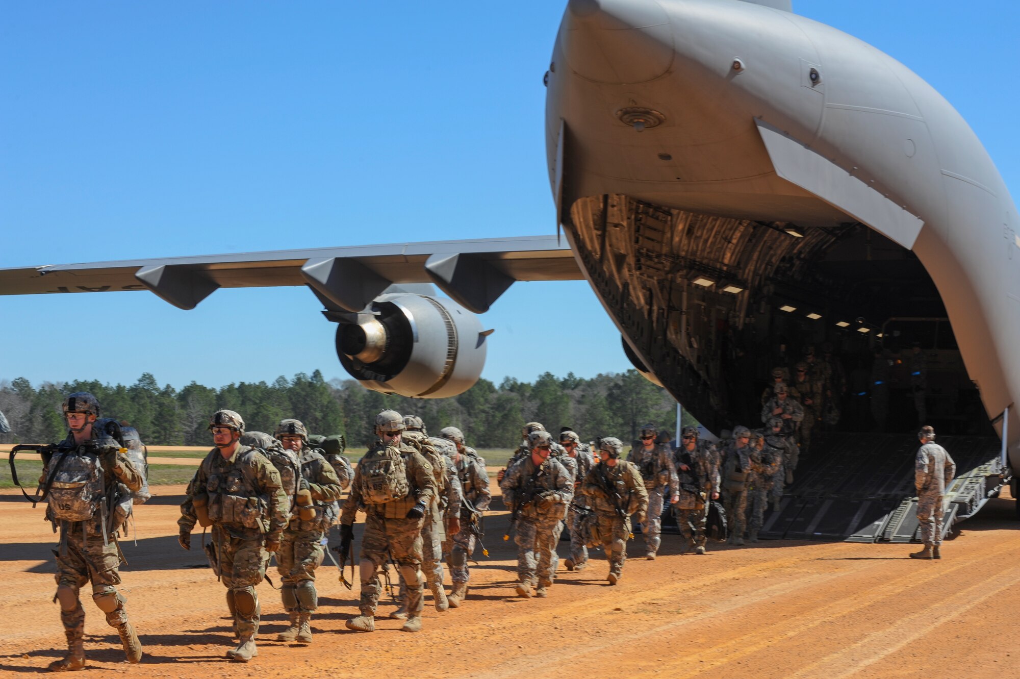 U.S. Army Soldiers depart from a C-17 Globemaster during GREEN FLAG 16-04, Feb. 17, 2016, at the Geronimo Landing Zone on Fort Polk, La. Among the service-members playing their part in the massive exercise was a team of observers, coaches and trainers from various Air Mobility Command bases. (U.S. Air Force photo/Senior Airman Harry Brexel)