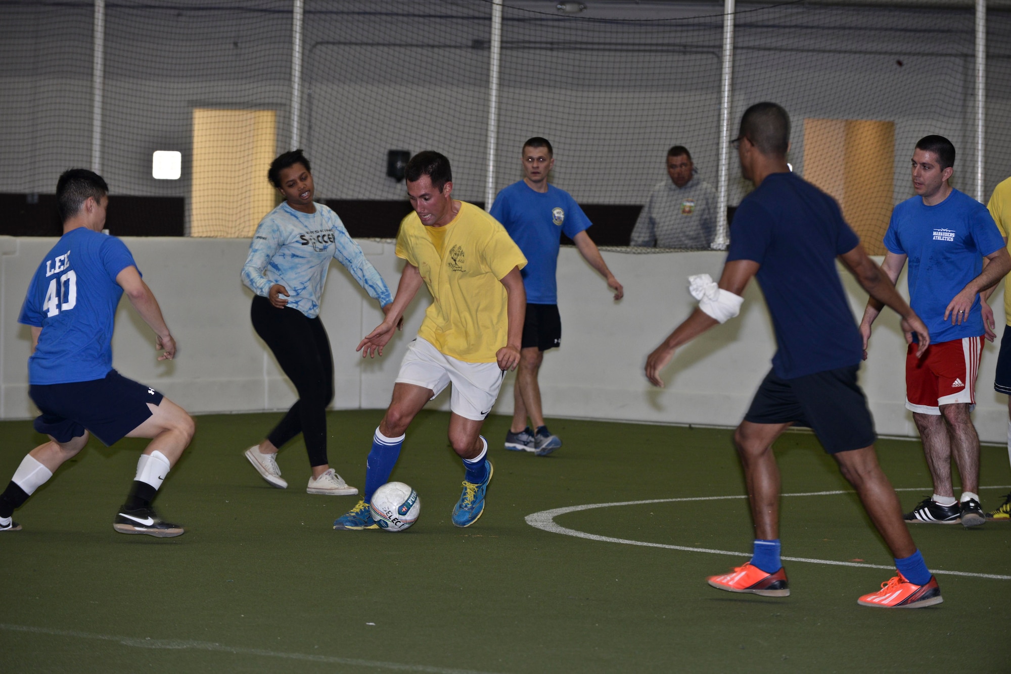 First Lt. David, 37th Bomb Squadron pilot, dribbles a soccer ball through the opposing team during an intramural game at Ellsworth Air Force Base, S.D., Feb. 16, 2016. Intramural soccer encourages Airmen to participate in friendly competition and promotes exercise for healthy lifestyles. For more information on intramural sports programs, call (605) 385-2264. (U.S. Air Force photo by Airman Sadie Colbert/Released)