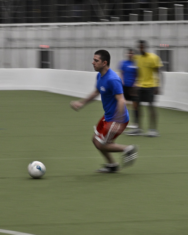 An Airman of the 432nd Attack Squadron hustles after a soccer ball during an intramural soccer game at Ellsworth Air Force Base, S.D., Feb. 16, 2016. The recreational soccer league is one of many intramural sports Ellsworth AFB offers throughout the year. For more information on intramural sports programs, call (605) 385-2264. (U.S. Air Force photo by Airman Sadie Colbert/Released)