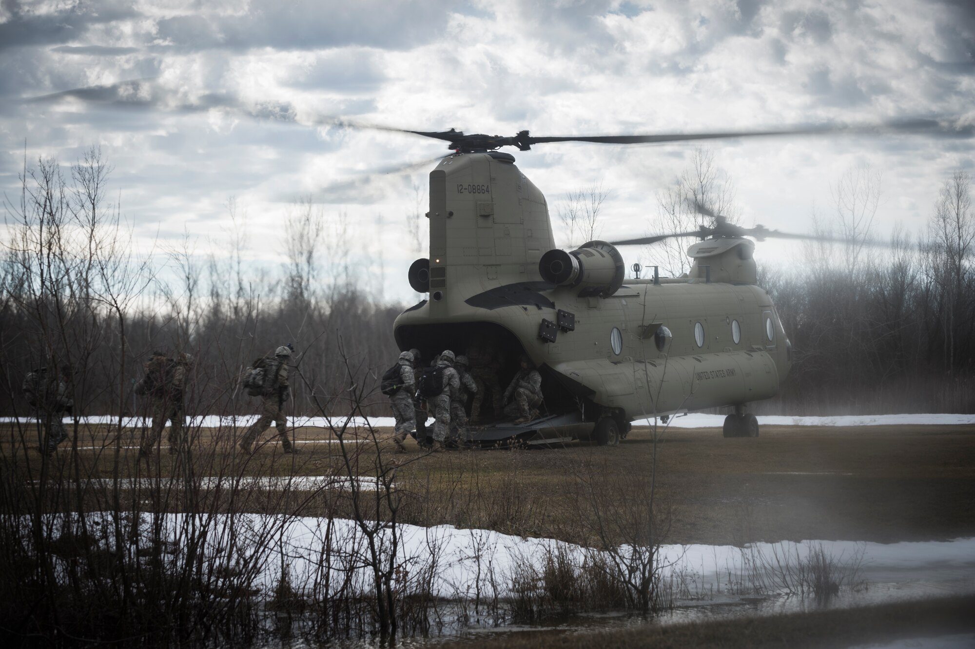 Soldiers from C Troop 2/101 Cavalry, from Buffalo, simulate breaking contact and boarding a U.S. Army CH-47 Chinook helicopter for extraction, Youngstown, NY, Feb. 20, 2016. The Soldiers are training in preparation for larger scale exercises to be held throughout the year. (U.S. Air National Guard photo by Staff Sgt. Ryan Campbell/Released)