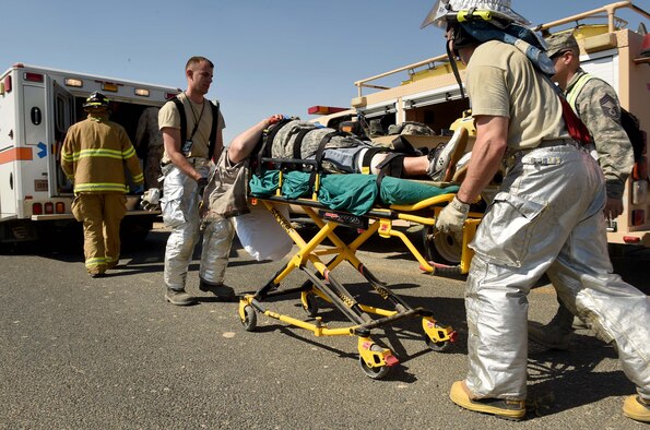 Firefighters from the 386th Air Expeditionary Wing move a mock patient to an ambulance for transport to the clinic during a joint medical exercise at an undisclosed location in Southwest Asia, Feb. 18, 2016. The 386th Air Expeditionary Wing partnered with soldiers from the 41st Combat Aviation Brigade and coalition forces medical personnel to conduct a medical exercise to test readiness and response times for first responders. (U.S. Air Force photo by Staff Sgt. Jerilyn Quintanilla)