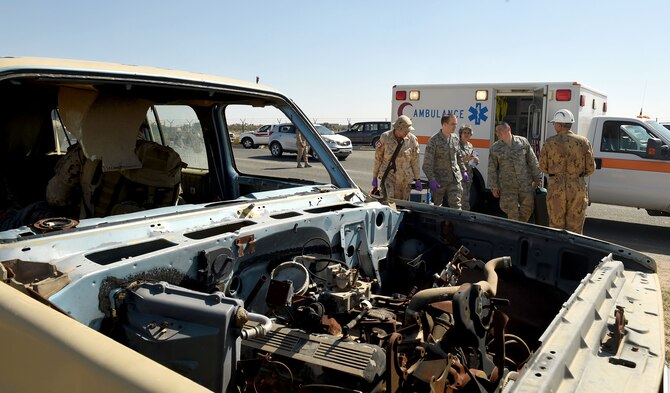 Medical personnel and firefighters from the 386th Air Expeditionary Wing and the Canadian Armed Forces work together to assess the scene of a simulated car crash at an undisclosed location in Southwest Asia, Feb. 18, 2016. The joint service exercise brought U.S. and coalition forces together to practice first response and medevac capabilities. (U.S. Air Force photo by Staff Sgt. Jerilyn Quintanilla)