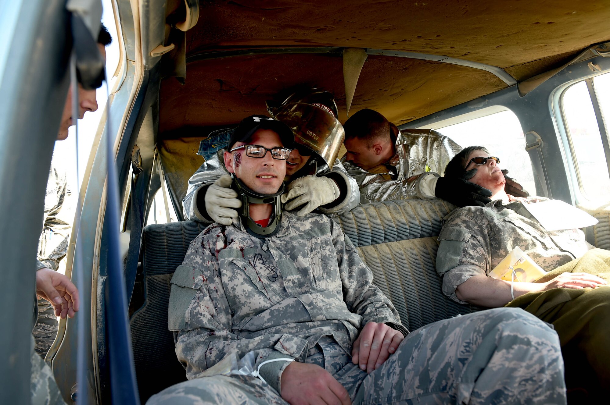 Firefighters from the 386th Air Expeditionary Wing try to stabilize mock casualties during a joint medical exercise at an undisclosed location in Southwest Asia, Feb. 18, 2016. The 386th Air Expeditionary Wing partnered with soldiers from the 41st Combat Aviation Brigade and coalition forces medical personnel to conduct a medical exercise to test readiness and response times for first responders. (U.S. Air Force photo by Staff Sgt. Jerilyn Quintanilla)