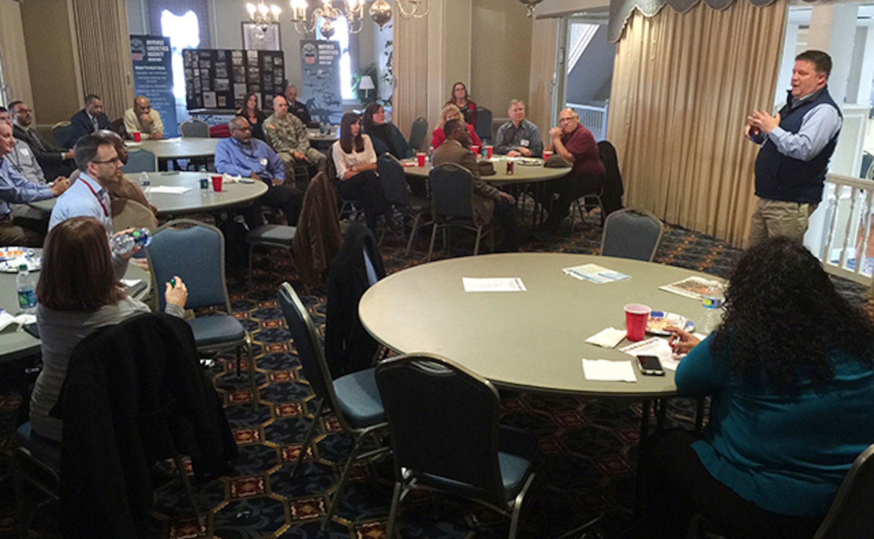 Virginia National Guard Public Affairs Officer Cotton Puryear discusses upcoming missions with other Central Virginia Military PAOs Feb. 18, 2016 at the Bellwood Club on Defense Supply Center, Richmond, Virginia, during the Central Virginia Military Public Affairs Officers luncheon hosted by Defense Logistics Agency Aviation’s PAO.  