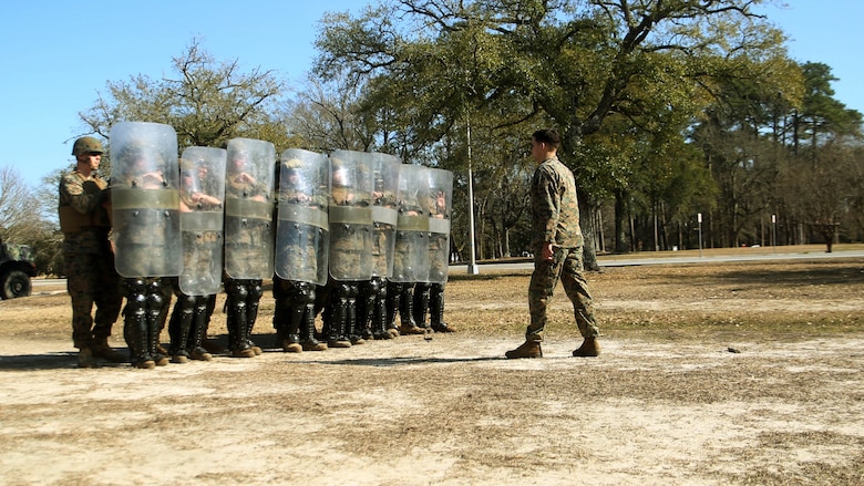 Marines with Combat Logistics Battalion 2 practice formations during non-lethal riot control training at  Marine Corps Base Camp Lejeune, N.C., Feb. 18, 2016. The focus of the training was to teach the Marines to deescalate situations without resulting to weapons that can either injure or kill someone. 