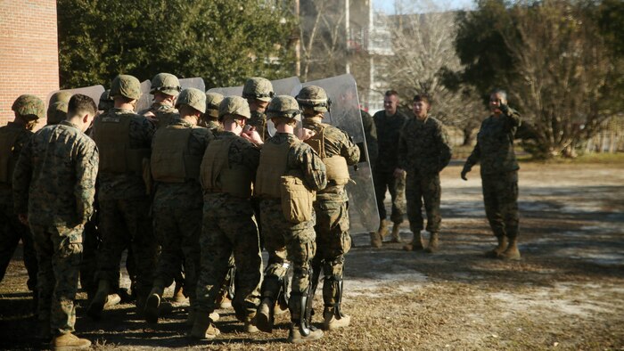 Marines with Combat Logistics Battalion 2 prepare to deescalate a crowd during non-lethal riot control training at  Marine Corps Base Camp Lejeune, N.C., Feb. 19, 2016. The focus of the training was to teach the Marines how to  deescalate situations without resorting to weapons that can injure or kill. 