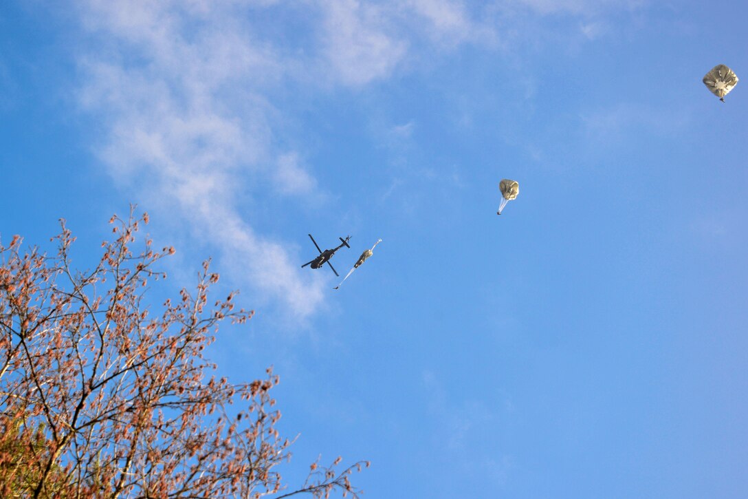 Paratroopers jump from a UH-60 Black Hawk helicopter while participating in airborne operations over Grafenwoehr Training Area, Germany, Feb. 18, 2016. Army photo by Sgt. Timothy MacDuffie