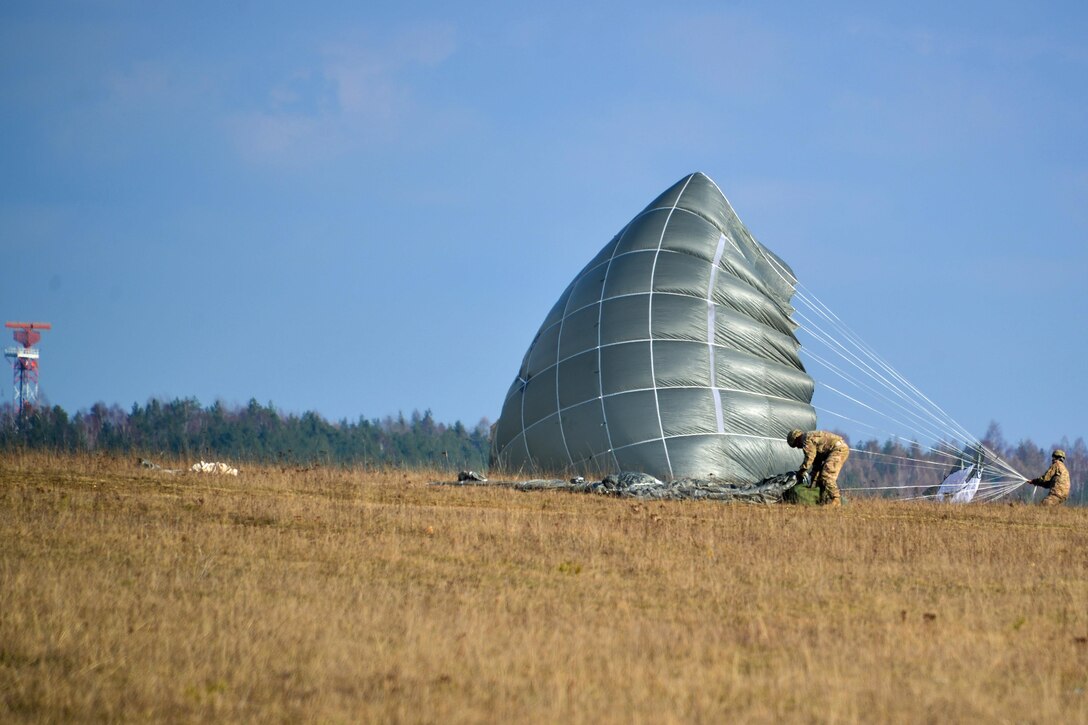 Paratroopers recovery their parachutes after jumping from a UH-60 Black Hawk helicopter over Grafenwoehr Training Area, Germany, Feb. 18, 2016. Army photo by Sgt. Timothy MacDuffie