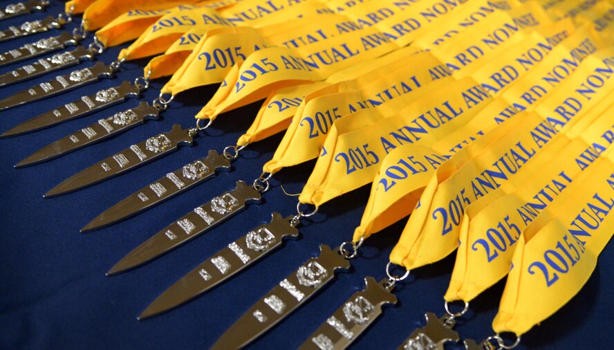 Annual award medallions sit atop a table in the Landing Zone during the annual awards banquet Feb. 19, 2016, at Cannon Air Force Base, N.M. This year’s ceremony paid tribute to distinguished men and women of the 27th Special Operations Wing for their outstanding leadership and service throughout 2015. (U.S. Air Force photo/Staff Sgt. Alexx Pons) 