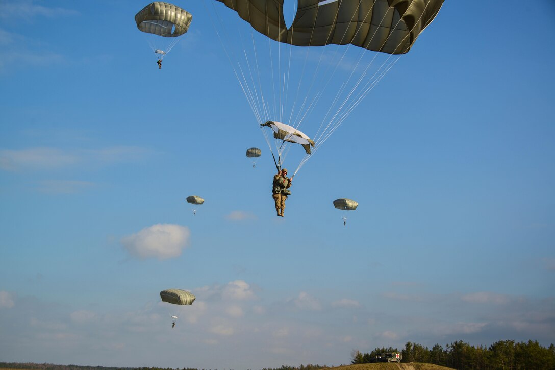 Paratroopers prepare to land on Bunker drop zone after jumping from a UH-60 Black Hawk helicopter over Grafenwoehr Training Area, Germany, Feb. 18, 2016. Army photo by Sgt. Timothy MacDuffie