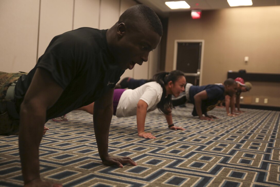 Capt. Nubari Kogbara, diversity officer for Marine Corps recruiting command, exercises with students during the Wake Up and Work Out event at Hyatt Regency Hotel in New Orleans La, Feb. 20, 2016. Wake Up and Work Out is part of the Empower Me Tour, a partnership between the Marine Corps and the United Negro College Fund to increase awareness among college and high school students to consider service in the Marine Corps as a career option. (U.S Marine Corps Photo by Cpl. Ian Ferro)