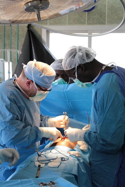 General surgeons U.S. Army Lt. Col. Charles Boggs, of 345th Combat Support Hospital, and Senegalese Defense Force Maj. Diop Balla, of Hopital Militaire de Ouakam, perform surgery on a patient to fix a hernia in Dakar, Senegal, Jan. 25, 2016. Boggs and other members of the U.S. Army Reserve are in partnership with the SDF to conduct a U.S. Army Africa Medical Readiness Training Exercise from Jan. 18-29. This exercise is the first of many scheduled throughout the year to demonstrate the strong partnership the U.S. has with its African partners. (U.S. Army photo by Capt. Charles An)