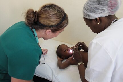 (Left) U.S. Army 1st Lt. Alyson Ochs, an emergency room nurse for Medical Support Unit Europe, 7th Civil Support Command, watches as Senegalese Defense Force Lt. Col. Aissatou Ngon Fall, a pediatric doctor, examines a patient at the Hopital Militaire de Ouakam, Dakar, Senegal, Jan. 26, 2016. Ochs and other members of the U.S. Army Reserve are in partnership with the SDF to conduct a U.S. Army Africa Medical Readiness Training Exercise, from Jan. 18-29. This exercise is the first of many scheduled throughout the year to demonstrate the strong partnership the U.S. has with its African partners. (U.S. Army photo by Capt. Charles An)