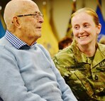 Dec. 31, 2015-Sergeant first class (SFC) Vickery-Unigarro, a current 100th Training Division Soldier, looks on as her grandfather finds out that his tour of the US Army Human Resources Command Center, is actually a ceremony in honor of his service during WWII. Sgt. (Ret.) Vickery, 95, received the World War II Victory Medal, the Asiatic Pacific Campaign Medal, and the American Campaign Medal for his service in the Army Air Corps from June, 1942, to October, 1945 from Brig. Gen. James Iacocca, Adjutant General of the U.S. Army. (Army photo by: 1LT Alicia Carver, 100th TD)