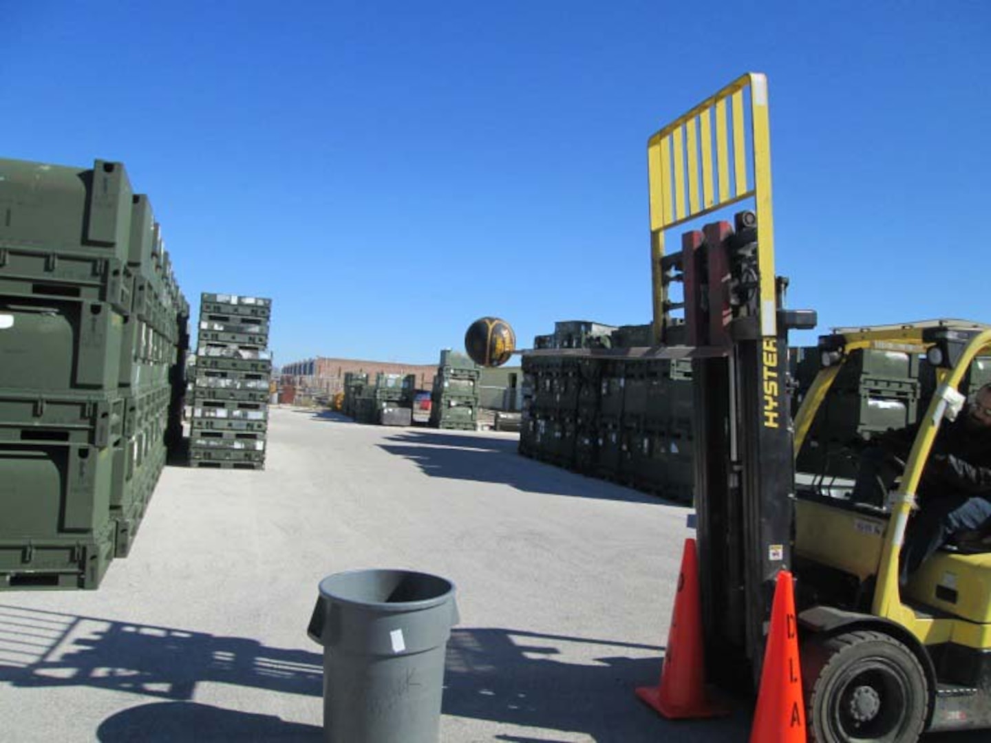 A participant uses a forklift to drop a basketball into a receptacle during DLA Distribution Corpus Christi’s annual Forklift Rodeo.