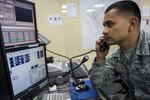 Staff Sgt. Camilo Guzman, 902nd Security Forces Squadron Base Defense Operations Center controller, answers the “Crime Stoppers” hotline phone Feb. 23 at Joint Base San Antonio-Randolph. The Crime Stoppers hotline allows JBSA-Randolph members to report suspicious activity on base without having to reveal their identity.(U.S. Air Force photo by Airman 1st Class Stormy Archer)