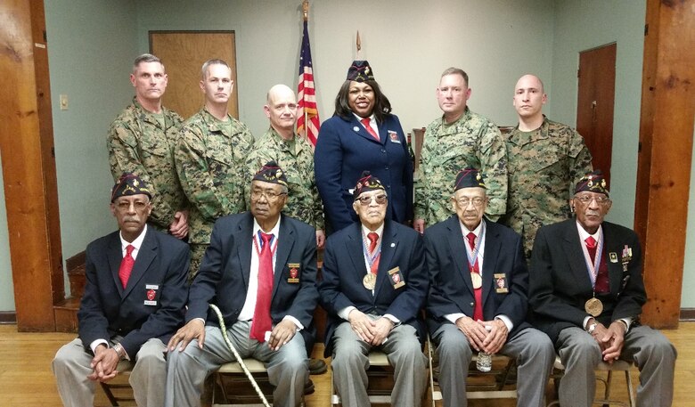 Marines with 3rd Civil Affairs Group, Force Headquarters Group, Marine Forces Reserve, pose for a picture with Montford Point Marines, Feb. 6, 2016, during a drill weekend. The Marines were able to thank the veterans for their contributions and received the opportunity to ask the Montford Point Marines questions about their service in battles ranging from World War II to Vietnam. 