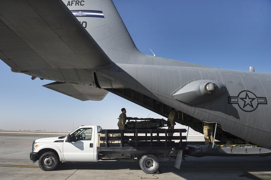 Airmen load a C-130 Hercules aircraft with medical equipment on Al Udeid Air Base, Qatar, Feb. 11, 2016. The airmen are assigned to the 379th Expeditionary Aeromedical Evacuation Squadron. Air Force photo by Staff Sgt. Corey Hook