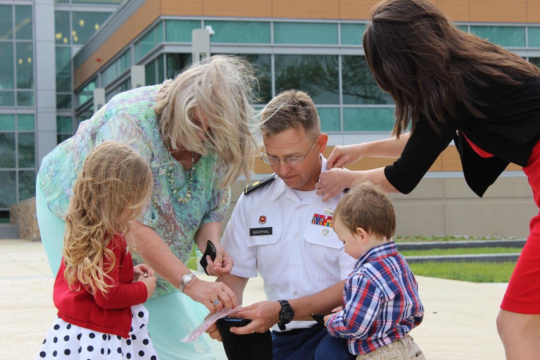 The family of now Maj. David MacPhail pin on his new rank insignia during his May 1, 2015, promotion ceremony. A career officer, he helped manage the construction of the U.S. Army Medical Research Institute for Chemical Defense at Aberdeen Proving Ground, Maryland, while serving with the U.S. Army Corps of Engineers, Baltimore District.