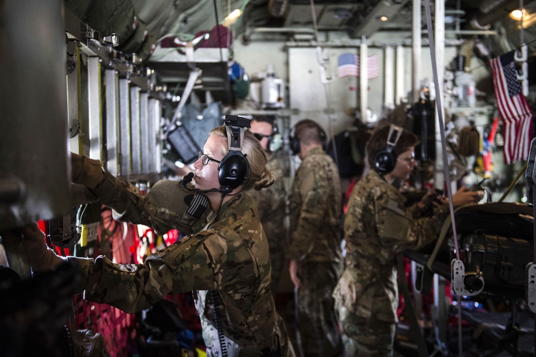 Air Force Senior Airman Haley Lecomte, foreground, Air Force Capt. Tracie Coy, right, and other airmen work to adjust the configuration inside of a C-130 Hercules aircraft during an aerial medical evacuation mission on Al Udeid Air Base, Qatar, Feb. 11, 2016. Lecomte and Coy are assigned to the 379th Expeditionary Aeromedical Evacuation Squadron. Air Force photo by Staff Sgt. Corey Hook