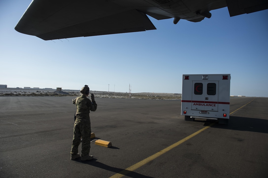 Air Force Senior Airman Haley Lecomte guides an ambulance to the back of a C-130 Hercules aircraft at an undisclosed location in Southwest Asia, Feb. 11, 2016. Lecomte is assigned to the 379th Expeditionary Aeromedical Evacuation Squadron. Air Force photo by Staff Sgt. Corey Hook