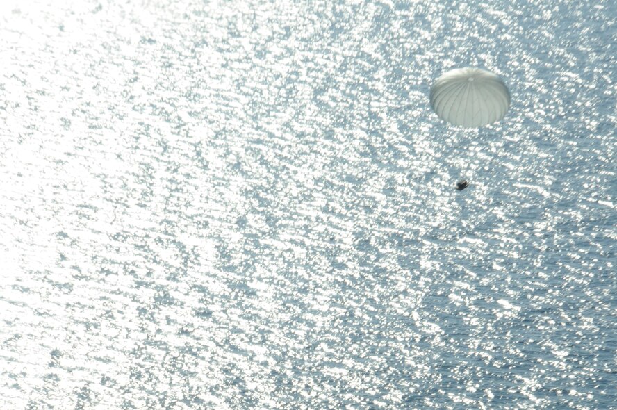 A pallet floats down into the Pacific Ocean on Jan. 31, 2016. The pallet was dropped from a C-130 Hercules during a concept operation completed by the 94th Airlift Wing and Joint Partners. (U.S. Air Force Photo by Senior Airman Miles Wilson)