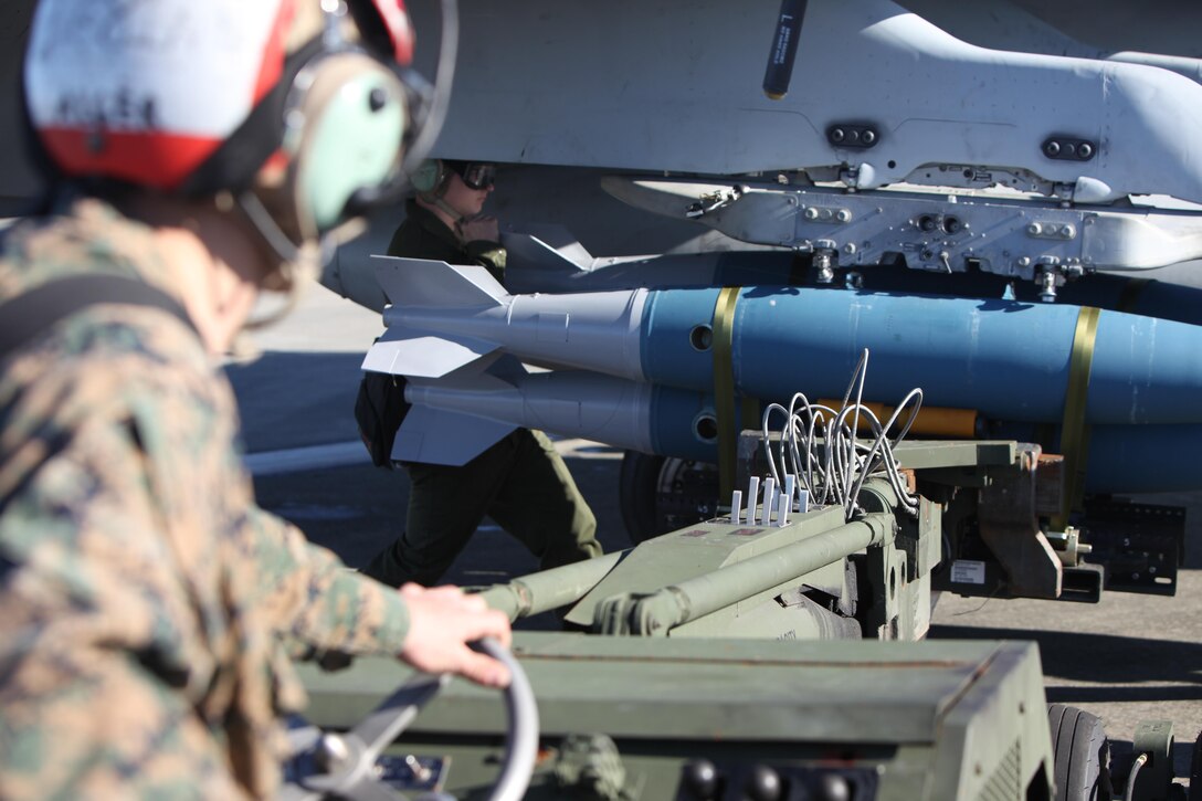 Marines operating an A/S 32K-1A/1B/1C SATS Weapon Loader load BDU-45 practice bombs onto an F/A-18 Hornet during Exercise Coastal Predator at Marine Corps Air Station Cherry Point, N.C., Feb. 16, 2016. The practice bombs fall according to the trajectory of the aircraft while in flight and is used for training purposes. Coastal Predator is an exercise that includes Marine Corps and Army aviation assets along with Air Force personnel and civilian contractors to conduct Forward Air Controller Airborne training in accordance with the pre-deployment training program.  (U.S. Marine Corps photo by Cpl. Jason Jimenez/Released)