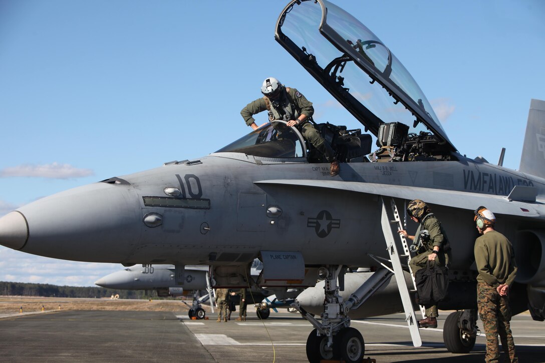 Pilots exit an F/A-18 Hornet to swap with a different crew during a hot loading procedure during Exercise Coastal Predator at Marine Corps Air Station Cherry Point, N.C., Feb. 16, 2016. Hot loading, aka hot rearming, is a reloading procedure completed while the aircraft’s engine is still running, drastically reducing the time to get back in the fight. Coastal Predator is an exercise that included Marine Corps and Army aviation assets along with Air Force personnel and civilian contractors to conduct Forward Air Controller Airborne training in accordance with the pre-deployment training program.  (U.S. Marine Corps photo by Cpl. Jason Jimenez/Released)