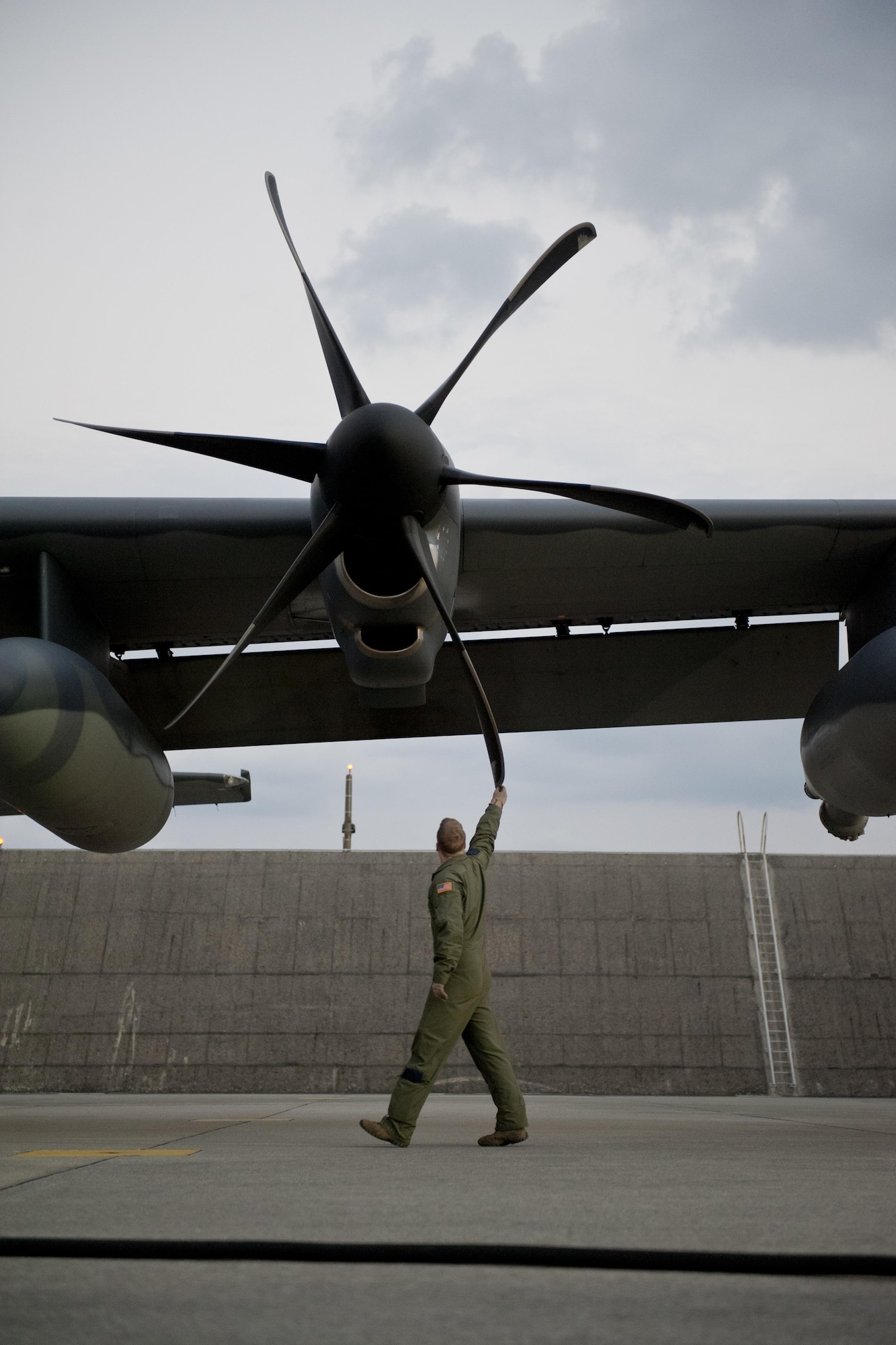 U.S. Air Force Senior Airman Tim Manzer, 17th Special Operations Squadron loadmaster, inspects an MC-130J Commando II prior to a sortie Feb. 17, 2016, at Kadena Air Base, Japan. Manzer participated in an aerial exercise involving a five-ship formation flight, cargo drops, short runway landings and takeoffs, and helicopter air-to-air refueling. (U.S. Air Force photo by Senior Airman Peter Reft/Released)