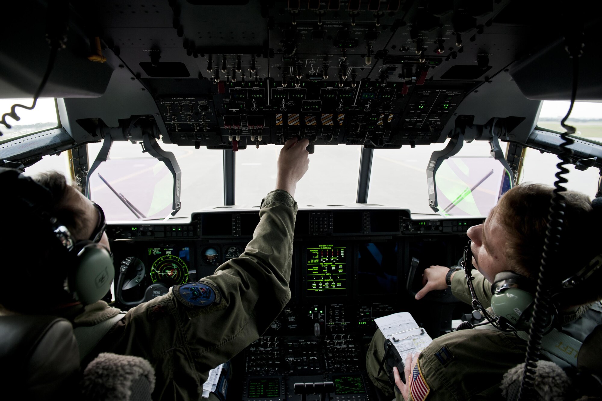 U.S. Air Force Maj. Brad Talley, 17th Special Operations Squadron MC-130J Commando II instructor pilot, and Capt. Jerome Harms, 17th SOS MC-130J pilot, run through a pre-flight checklist during a training exercise Feb. 17, 2016, at Kadena Air Base, Japan. Talley and Harms piloted the lead aircraft in a five-ship formation flight. (U.S. Air Force photo by Senior Airman Peter Reft/Released)