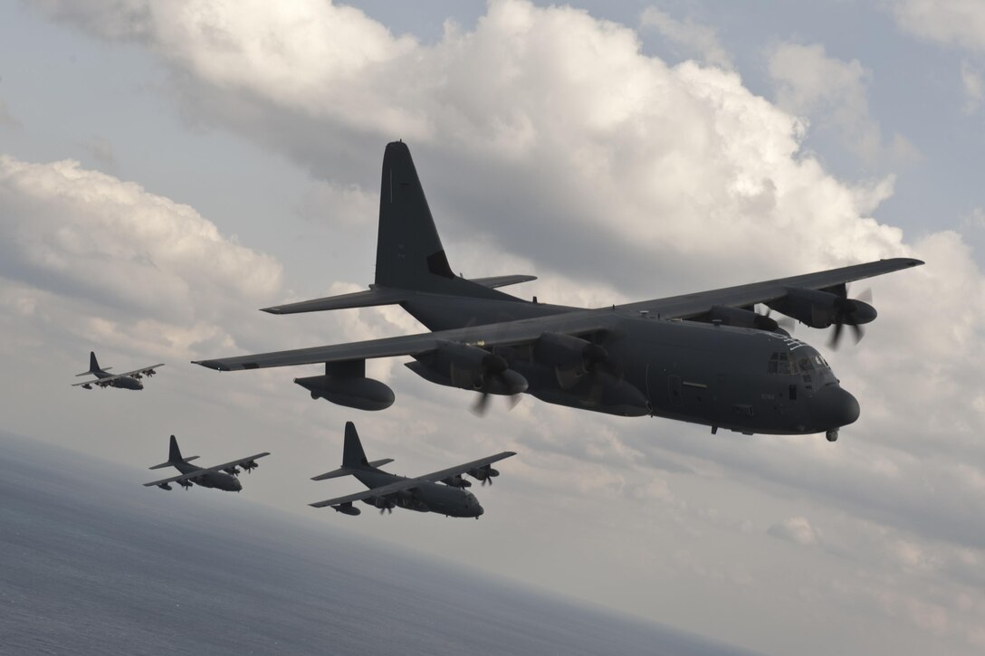 U.S. Air Force MC-130J Command IIs assigned to the 17th Special Operations Squadron fly in formation Feb. 17, 2016, off the coast of Okinawa, Japan. The 17th SOS conducted a unit-wide training exercise which tasked the entire squadron with a quick-reaction, full-force sortie involving a five-ship formation flight, cargo drops, short runway landings and takeoff, and helicopter air-to-air refueling. (U.S. Air Force photo by Senior Airman Peter Reft/Released)