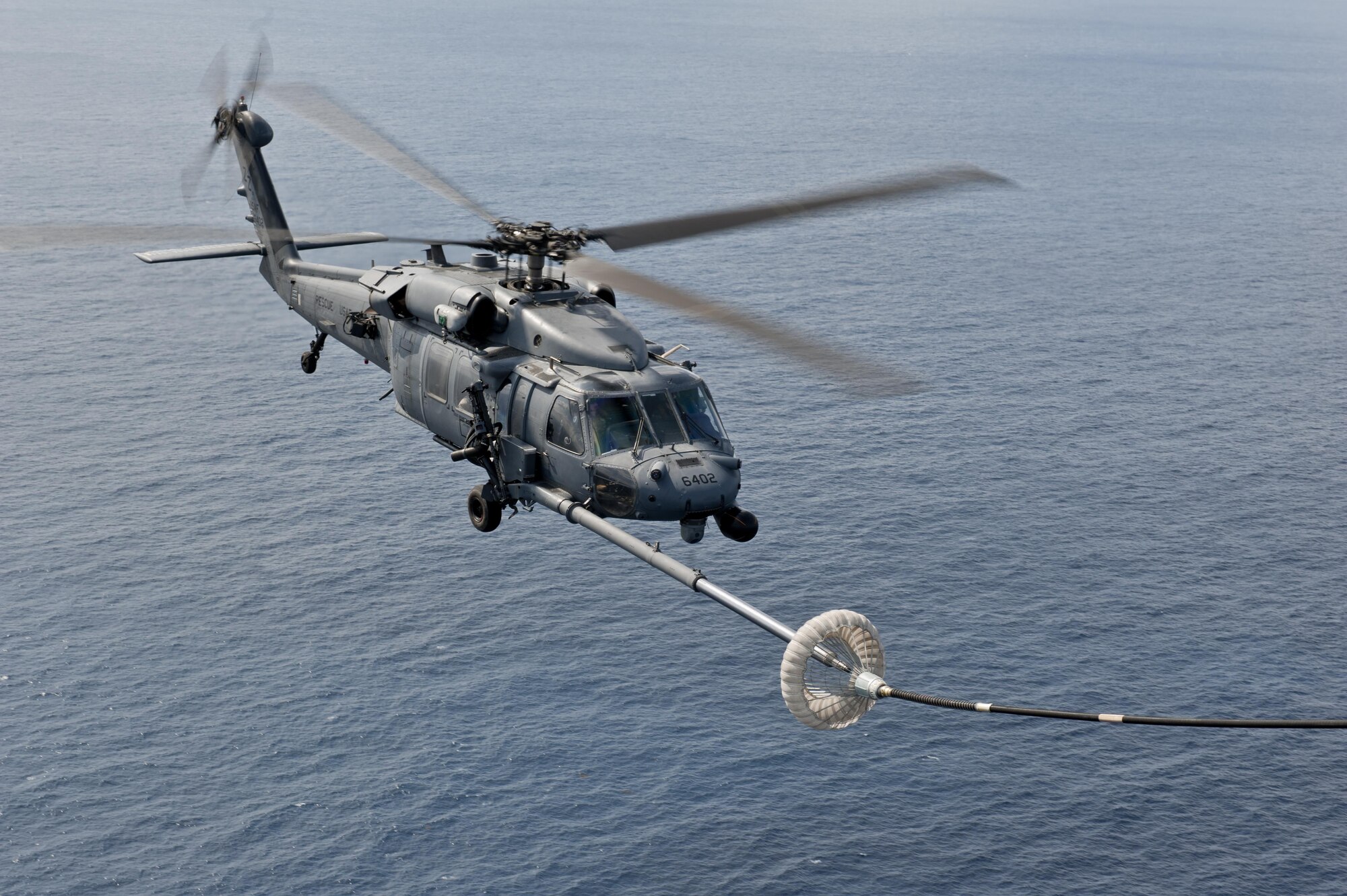 A U.S. Air Force HH-60G Pave Hawk helicopter assigned to the 33rd Rescue Squadron performs in-flight refueling during a training exercise Feb. 17, 2016, off the coast of Okinawa, Japan. The 33rd RS performs military personnel recovery, civil search and rescue, medical evacuation, disaster response, and humanitarian assistance. (U.S. Air Force photo by Senior Airman Peter Reft/Released)