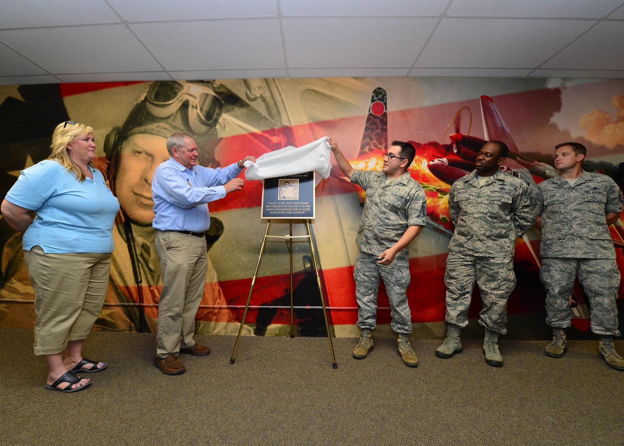Traci Megenney,Chief Master Sgt. Richard Etchberger’s granddaughter, Cory Etchberger, Chief Master Sgt. Richard Etchberger’s son, Master Sgt. Joseph Ippolito, Master Sgt. Martin Jackson, and Master Sgt. Alex Kuh, from the 56th Air Communications Squadron, unveil a plaque during the groundbreaking ceremony for the Chief Master Sargent Richard Etchberger Cyber Operations Center on Joint Base Pearl Harbor Hickam, Hawaii, Feb 17, 2016. Etchberger and Megenney are visited JBPHH to attend the Medal of Honor Rededication ceremony in honor of Chief Master Sgt. Richard Etchberger. (U.S. Air Force photo by Tech. Sgt. Aaron Oelrich/Released)