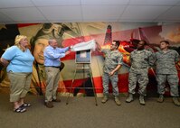 Traci Megenney,Chief Master Sgt. Richard Etchberger’s granddaughter, Cory Etchberger, Chief Master Sgt. Richard Etchberger’s son, Master Sgt. Joseph Ippolito, Master Sgt. Martin Jackson, and Master Sgt. Alex Kuh, from the 56th Air Communications Squadron, unveil a plaque during the groundbreaking ceremony for the Chief Master Sargent Richard Etchberger Cyber Operations Center on Joint Base Pearl Harbor Hickam, Hawaii, Feb 17, 2016. Etchberger and Megenney are visited JBPHH to attend the Medal of Honor Rededication ceremony in honor of Chief Master Sgt. Richard Etchberger. (U.S. Air Force photo by Tech. Sgt. Aaron Oelrich/Released)
