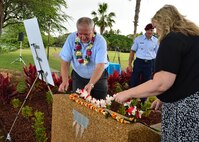 Traci Megenney, Chief Master Sgt. Richard Etchberger’s granddaughter, and Cory Etchberger, Chief Master Sgt. Richard Etchberger’s son, place a lei at the top of the Congressional Medal of Honor Memorial during a rededication ceremony at Aloha Aina Park on Joint Base Pearl Harbor-Hickam, Hawaii, Feb. 19, 2016. Base officials rededicated the Medal of Honor Monument at JBPHH to recognized Medal of Honor recipients, Chief Master Sgt. Richard Etchberger and Airman 1st Class William Pitsenbarger. (U.S. Air Force photo by Tech. Sgt. Aaron Oelrich/Released)