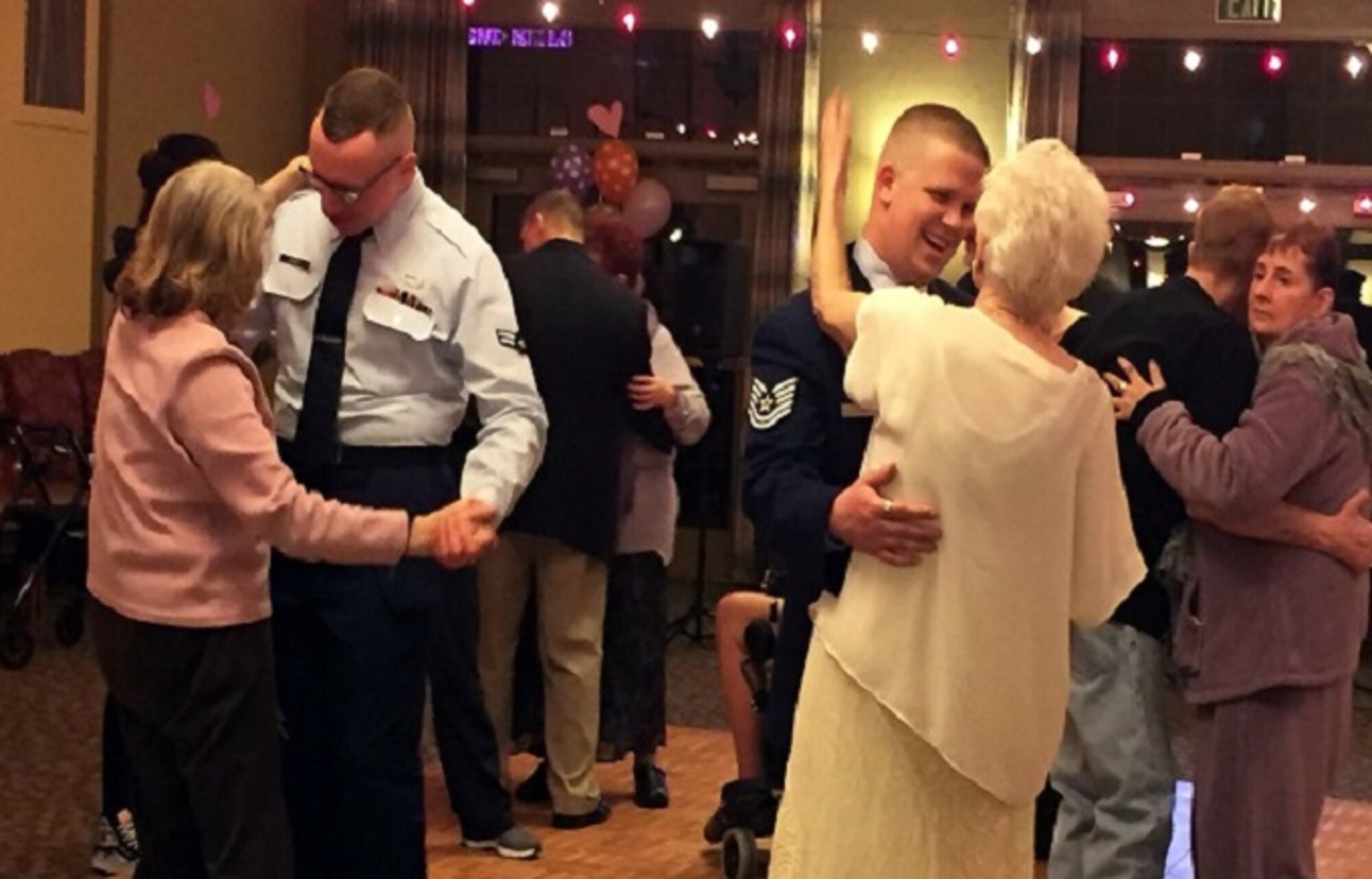 Airmen from Hill Air Force Base dance with residents of Chancellor Gardens, an assisted living facility in Clearfield, during a Valentine's Day dance Feb. 11, 2016. (Courtesy photo)