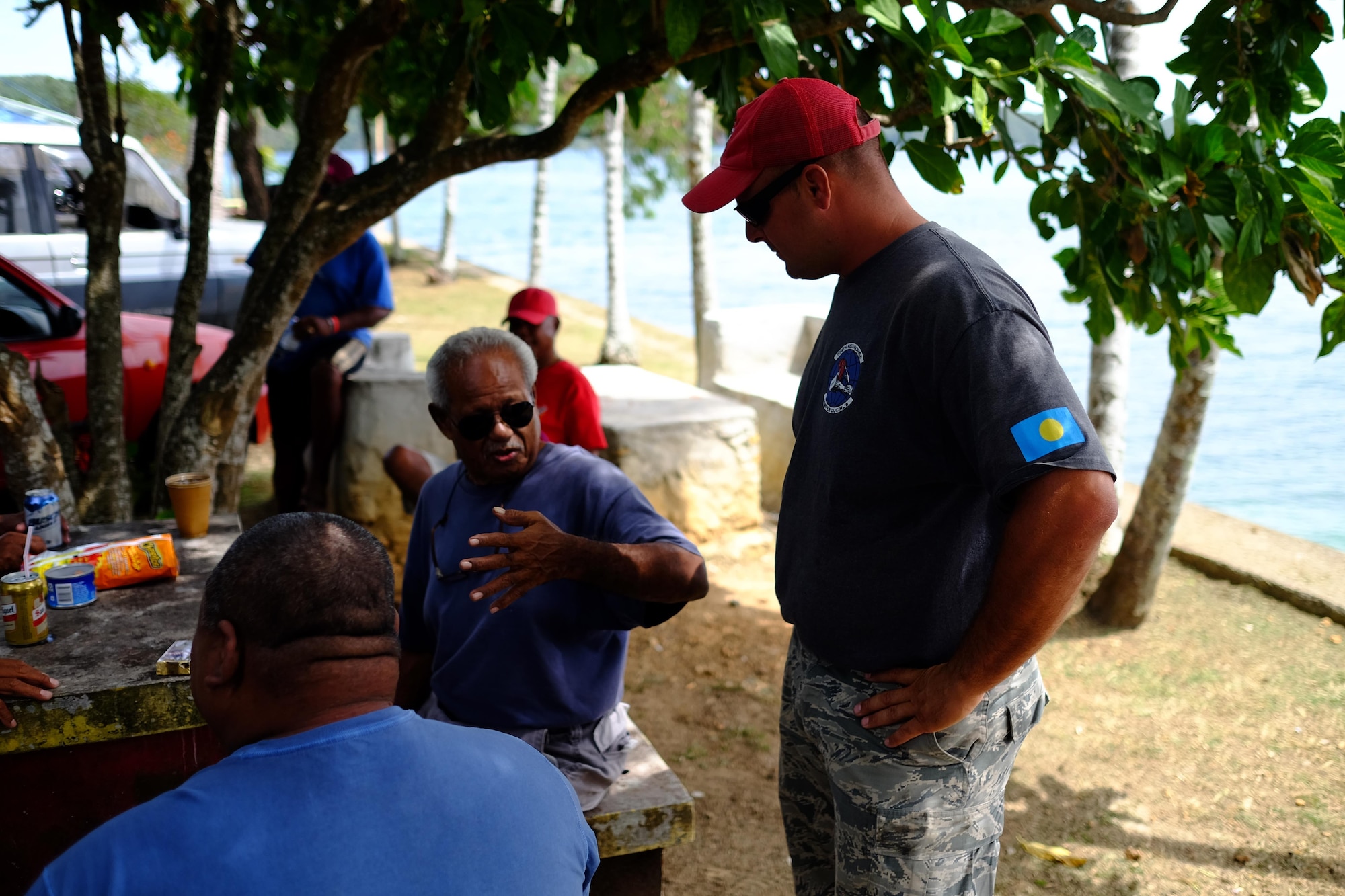 U.S. Air Force Staff Sgt. Chad King, Civil Action Team 554-01 heavy equipment operator from the 554th Red Horse Squardon at Andersen Air Force Base, Guam, speaks to local Palauan residents in Koror, Palau, Feb. 18, 2016. Airmen of CAT 554-01 provided construction capabilities, apprenticeship training, medical outreach, and community engagement opportunities while deployed to the Republic of Palau. (U.S. Air Force photo by Staff Sgt. Christopher Stoltz/Released)