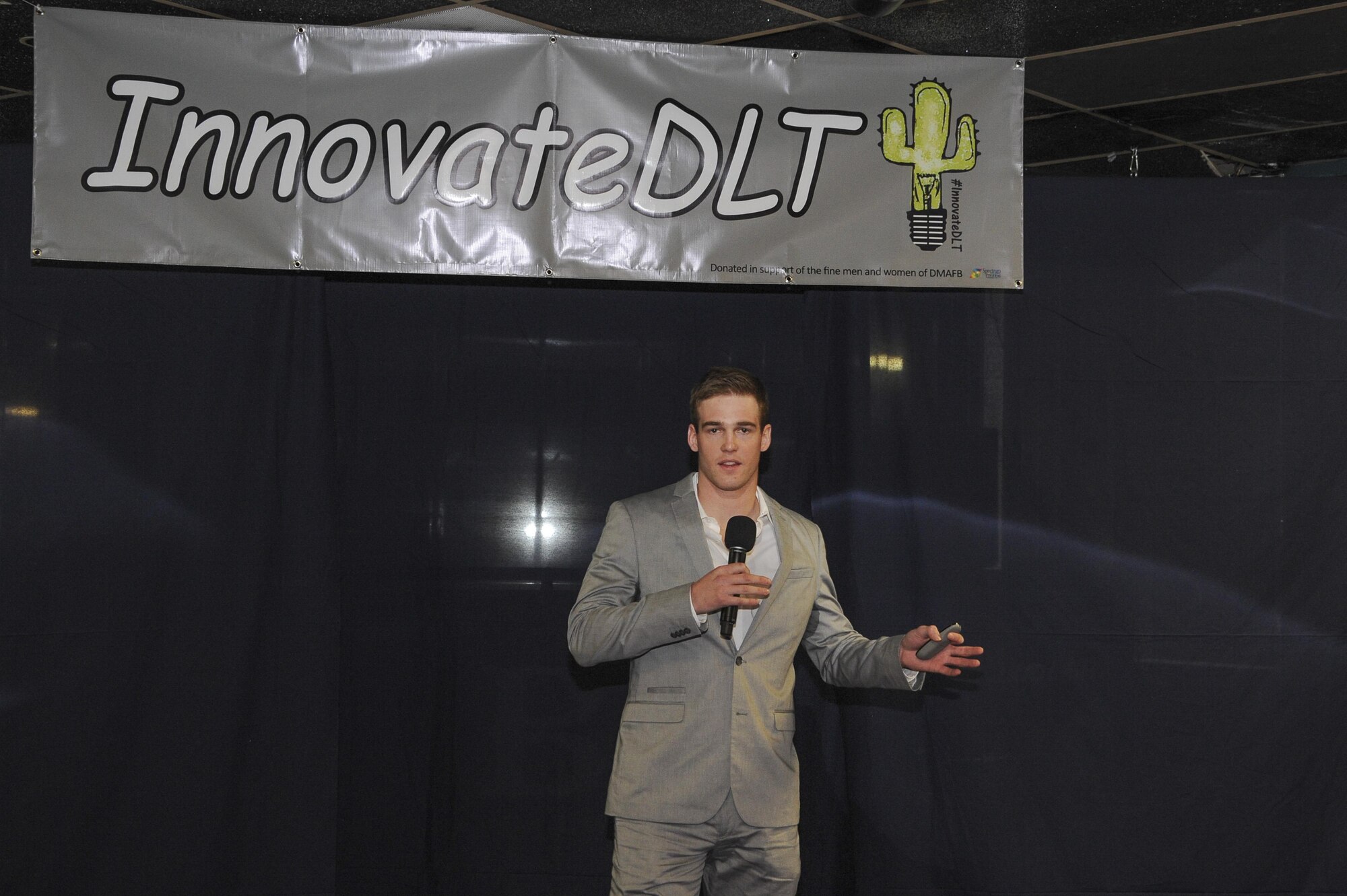 U.S. Air Force 2nd Lt. Benjamin Persian, 355th Contracting Squadron contract administrator, presents his proposal for adjustable standing desks in the workplace during the #InnovateDLT event held at Davis-Monthan Air Force Base, Ariz., Jan. 29, 2016. The event gave Airmen an opportunity to pitch their innovative ideas to the base commander and a panel of judges. (U.S. Air Force photo by Airman 1st Class Ashley N. Steffen/Released)