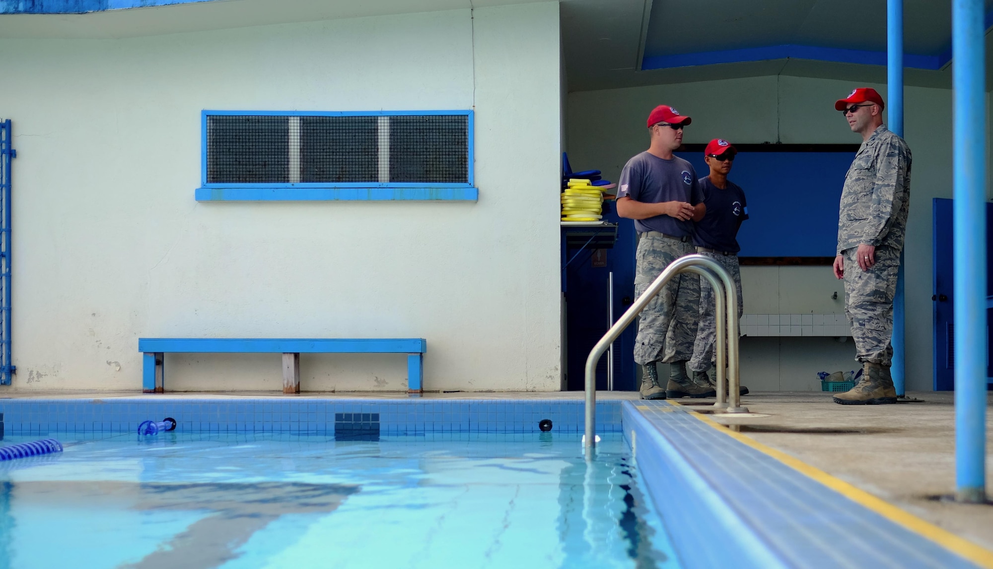 U.S. Air Force Tech. Sgt. Branden Behee, Civil Action Team 554-01 utilities craftsman, and Tech. Sgt. Paul Perez, CAT 554-01 electrician both from the 554th Red Horse Squardon at Andersen Air Force Base, Guam, brief Col. Allen Thibeaux, chief, Civil Engineer Division, Pacific Air Forces A4C, on their recently-completed project – The Palau National Olympic Swimming Pool.  The pool measured nearly 88,000 cubic feet and was stripped, resurfaced and re-tiled. (U.S. Air Force photo by Staff Sgt. Christopher Stoltz/Released)