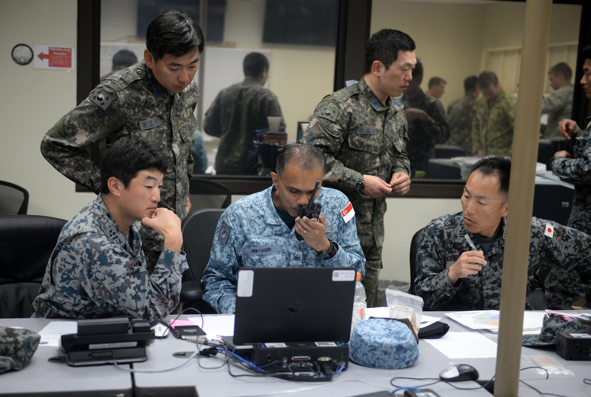 Airmen from the Japan Air Self Defense Force, Republic of Korea Air Force and Republic of Singapore Air Force participate in the command and control section of the final exercise of Partner Nation Silver Flag Feb. 19, 2016, at Andersen Air Force Base, Guam. The contingency environment training focused on bare-base beddown, sustainment operations and recovery after an attack. (U.S. Air Force photo by Senior Airman Joshua Smoot/Released)