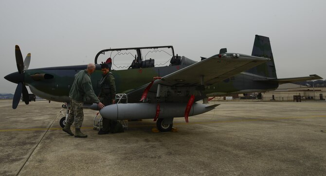 U.S. Air Force Col. Andrew Hansen, 51st Fighter Wing commander discusses the KA-1 Woongbi fighter aircraft with Republic of Korea air force Capt. Ahn, Hae-Chul, 237th Fighter Squadron pilot, during Buddy Wing 16-2 on Osan Air Base, ROK, Feb. 22, 2016. The exercise provides an opportunity for the allied forces to train together and strengthen tactics in the event of real-world contingencies. (U.S. Air Force photo by Senior Airman Kristin High/Released)