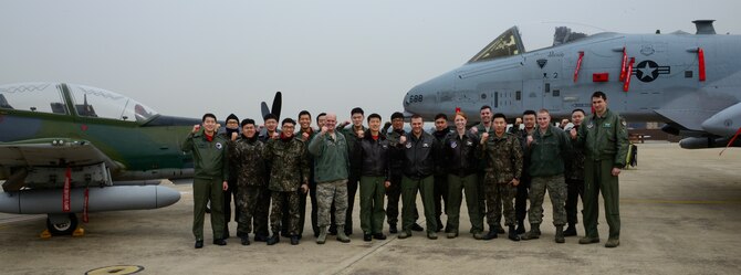 Personnel from the U.S. and Republic of Korea air forces pose for a group photo during Buddy Wing 16-2 on Osan Air Base, ROK, Feb. 22, 2016. The Buddy Wing exercise, conducted quarterly, is a combined program between the U.S. and ROKAF to promote solidarity and mutual understanding of all executed operations. (U.S. Air Force photo by Senior Airman Kristin High/Released)