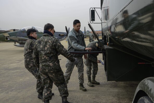 U.S. Air Force Airman 1st Class Christian Brancanto and Senior Airman Michael Campana, 51st Logistics Readiness Squadron fuels distribution operators, help Republic of Korea air force Master Sgts. Heo, Jae-bub and Yang, Hoon, 237th Aircraft Maintenance Unit crew chiefs, refuel their aircraft during Buddy Wing 16-2. The exercise provides an opportunity for the allied forces to train together and strengthen tactics in the event of real-world contingencies. (U.S. Air Force photo by Senior Airman Kristin High/Released)