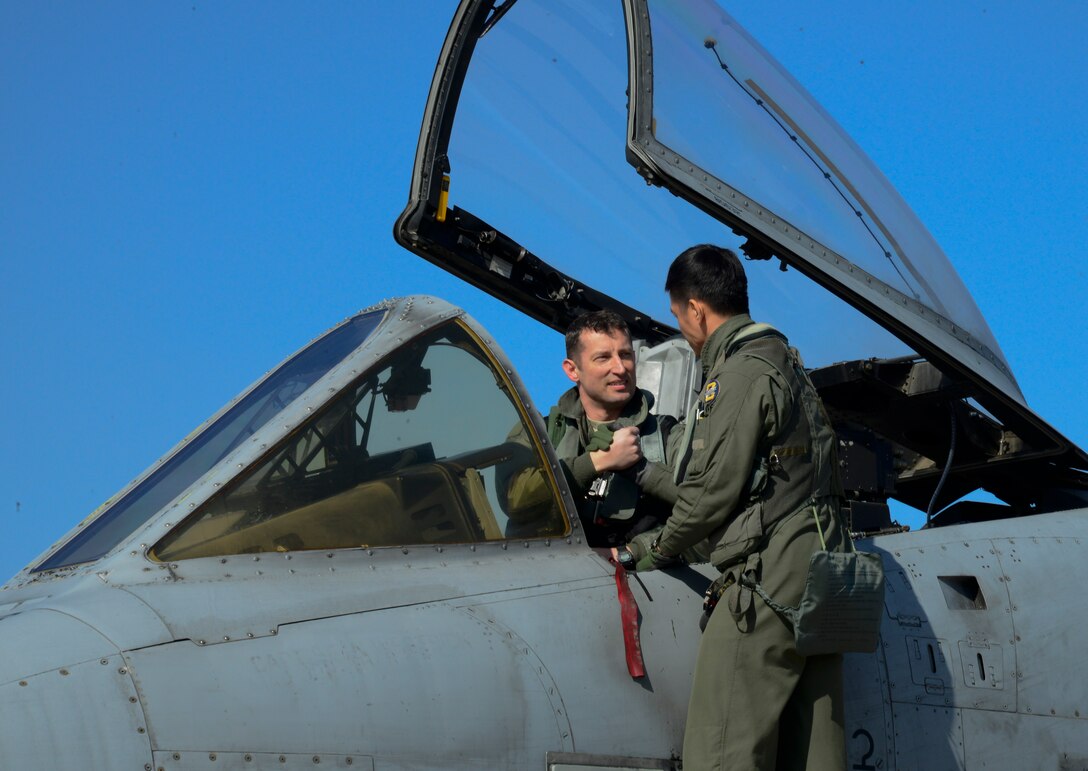 U.S. Air Force Maj. Jozsef Jonas, 25th Fighter Squadron pilot, shakes hands with Republic of Korea air force Capt. Ahn, Hae-Chul, 237th FS pilot, before take-off during Buddy Wing 16-2 on Osan Air Base, ROK, Feb. 24, 2016. Buddy Wing is conducted quarterly to sharpen interoperability between allied forces. (U.S. Air Force photo by Senior Airman Kristin High/Released)