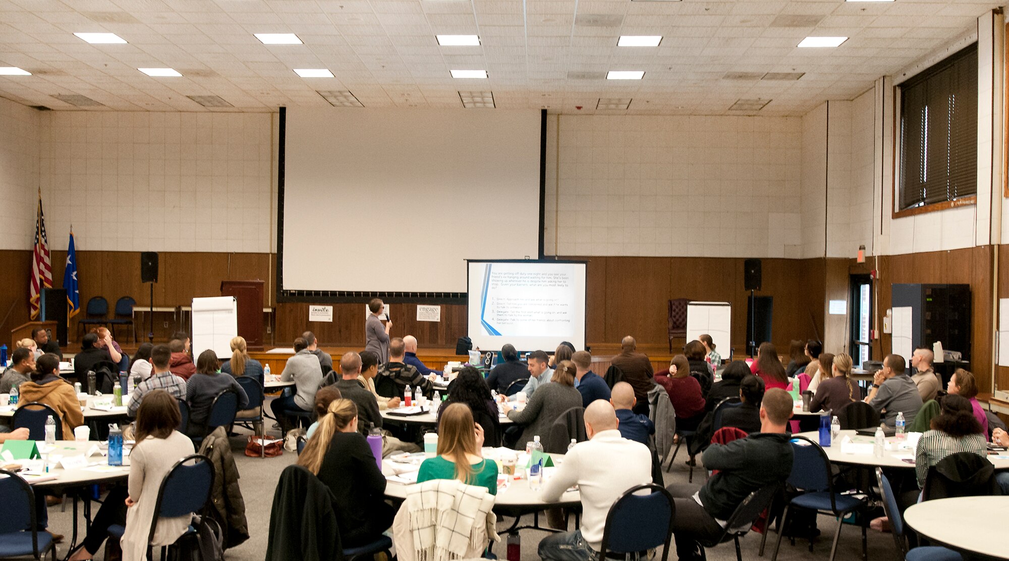 Airmen participate in a Green Dot violence prevention training session at the 459th Air Refueling Wing auditorium, Joint Base Andrews, Md., Feb. 24, 2106. 1,500 Airmen implementers are slated to be trained by Green Dot, a non-profit organization which aims to help reduce interpersonal violence in the home and workplace, including sexual, domestic, child abuse and bullying. The trained Airmen will then return to the workplace to train others. (U.S. Air Force photo by Staff Sgt. Kat Justen)