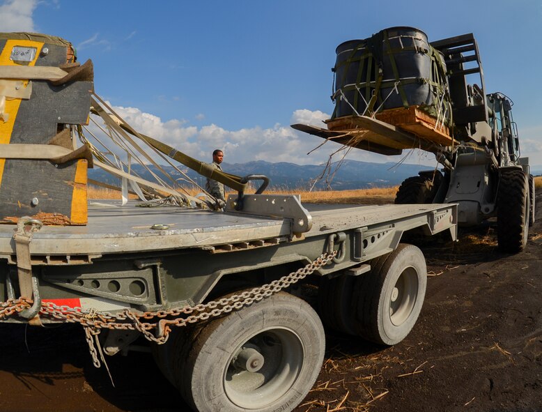 A U.S. Marine loads a recovered pallet onto a truck at the base of Mt. Fuji, Japan, Feb. 2, 2016. Yokota Air Base and Camp Fuji personnel coordinate to recover pallets used in Yokota cargo drop exercises. (U.S. Air Force photo by Airman 1st Class Elizabeth Baker/Released)