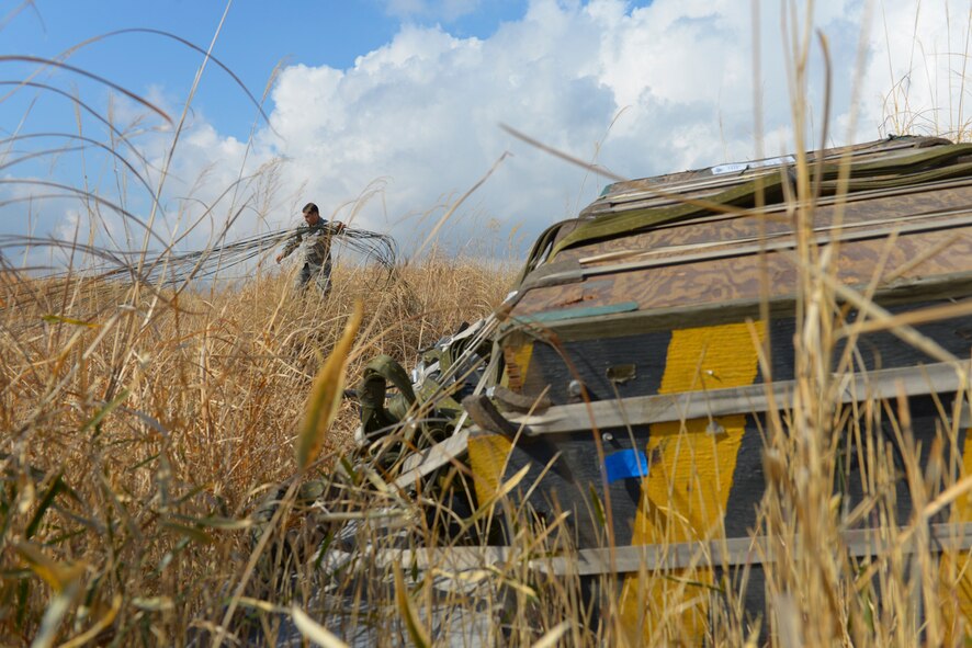 Staff Sgt. Joshua Mcdonald, 374th Logistics Readiness Squadron aerial delivery supervisor, recovers a parachute used in a heavy pallet drop at the base of Mt. Fuji, Japan, Feb. 2, 2016. Heavy pallets are used to simulate air drops of large equipment such as vehicles and boats. (U.S. Air Force photo by Airman 1st Class Elizabeth Baker/Released)